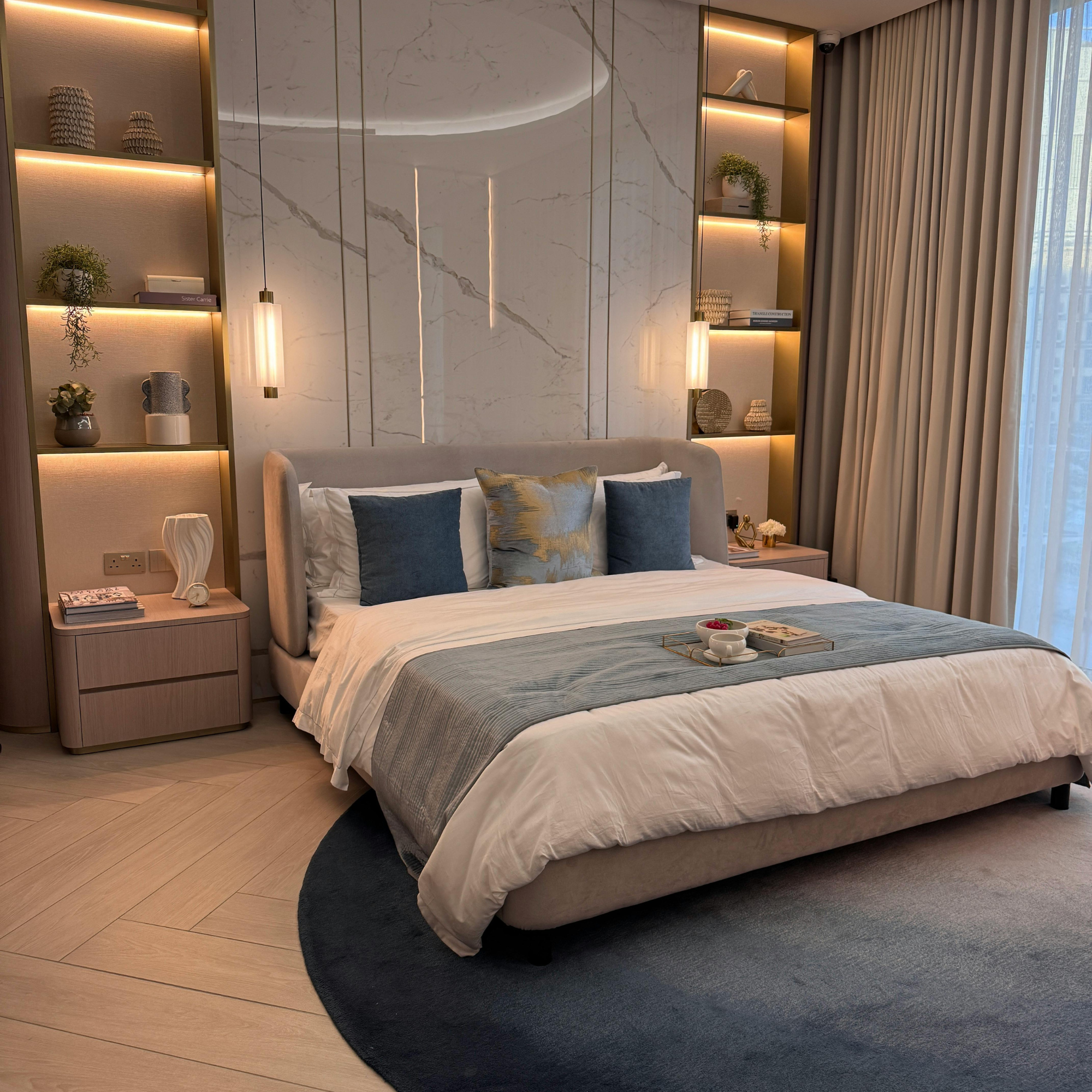 Luxury bedroom with marble wall and white duvet bedding