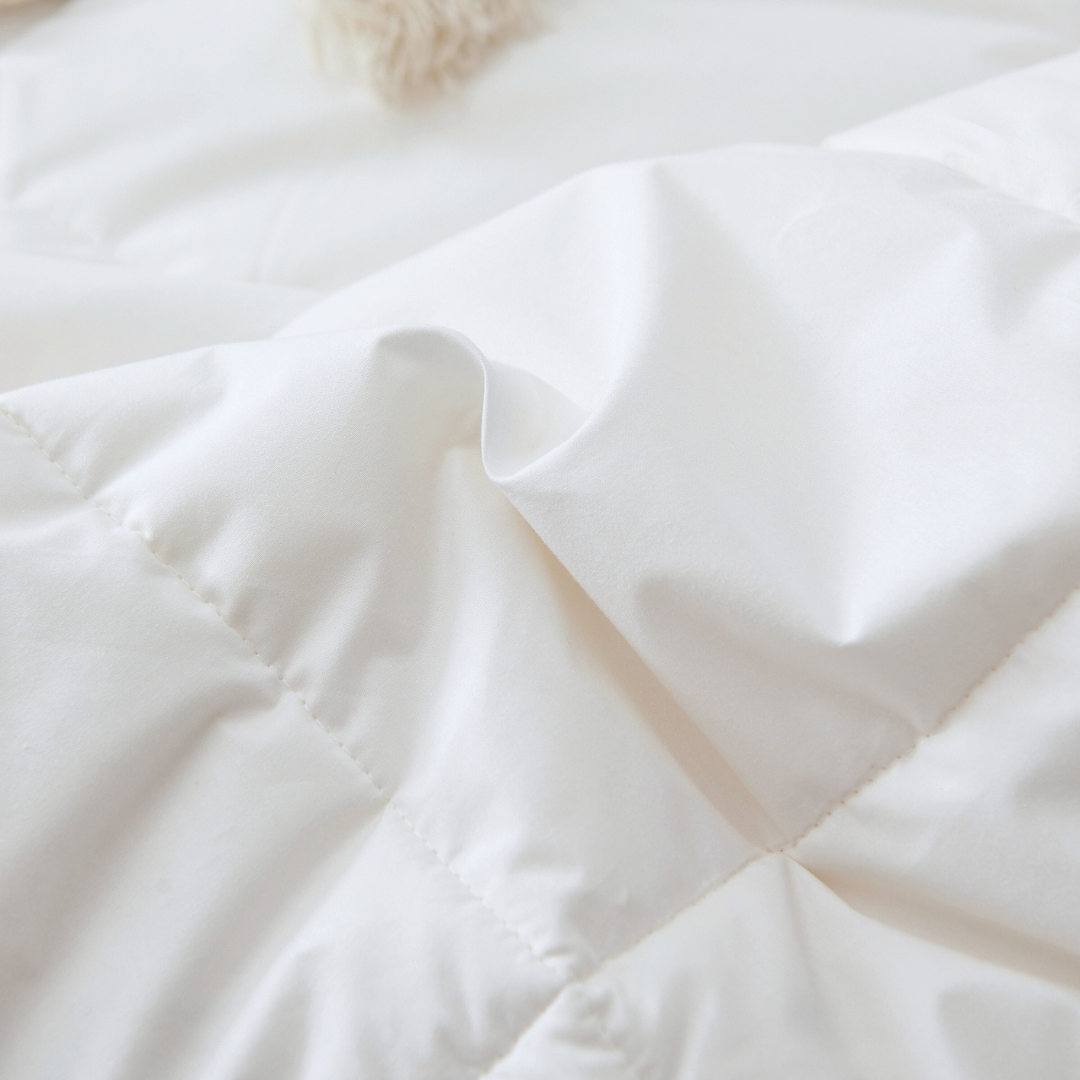 A close-up of hutterite down duvet, by Royal Elite, the best bedding company in Canada, showing soft cotton shell and baffle box seam.