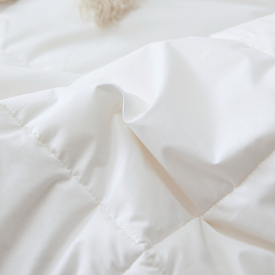 A close-up of hutterite down duvet, by Royal Elite, the best bedding company in Canada, showing soft cotton shell and baffle box seam.