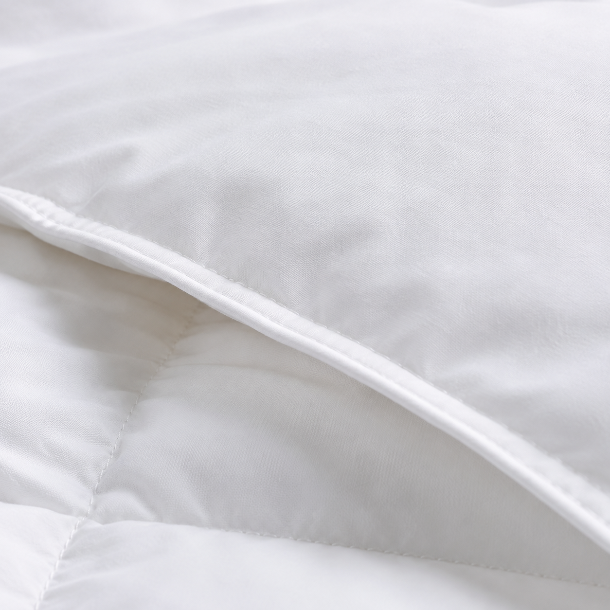 Close-up of the Royal Elite White Goose Down Duvet showing its 280 thread count percale cotton down-proof shell and finished seam.