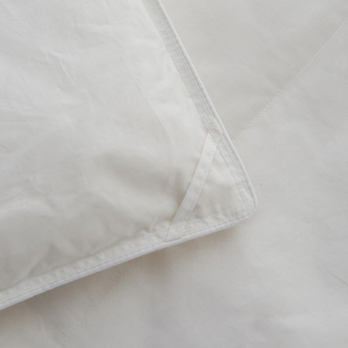 Close-up of the Royal Elite Feather & Down Duvet corner showing reinforced stitching and neatly finished edge construction.