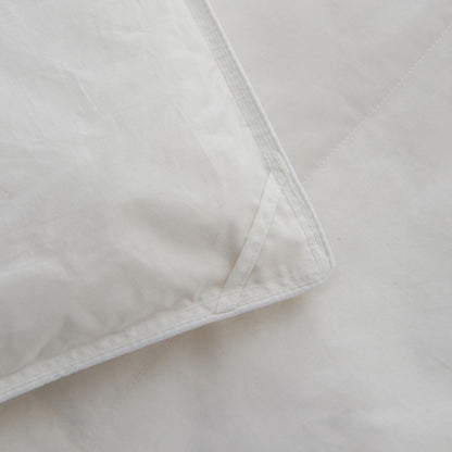 Close-up of the Royal Elite Feather & Down Duvet corner showing reinforced stitching and neatly finished edge construction.