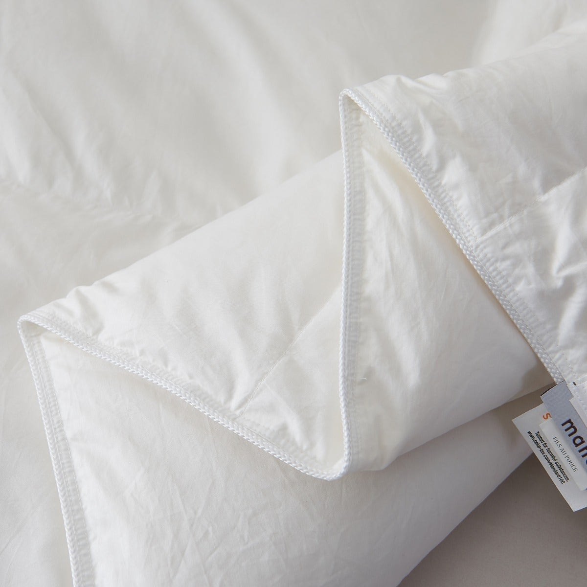 Close-up of the Royal Elite Feather Duvet showing its finished edges, reinforced stitching, and quilted construction details.